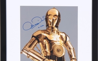 “C-3PO”. A signed colour photograph of the English actor Anthony Daniels (b. 1946) in his role as C-3PO. Framed.