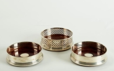 A pair of modern silver wine coasters and another with
