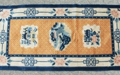 A CHINESE WOOL RUG with three motifs, orange ground