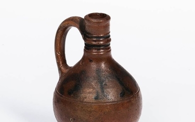 Small Cobalt-decorated Westerwald Stoneware Jug, 17th century, the brown-glazed jug with tall tooled neck, applied strap handle, and co