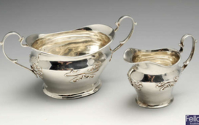 An Edwardian silver sugar bowl and matching cream jug.