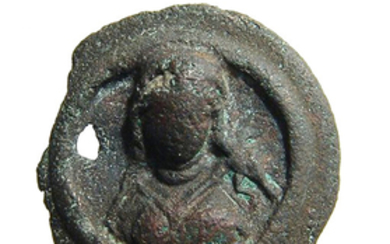 A Roman bronze medallion depicting a woman