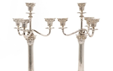 A pair of George III style silver candelabra, stems shaped as corinthian columns; swirled lighting arms. Copenhagen 1919. Weigh 2788 gr. H. 4.,5 cm. (2)