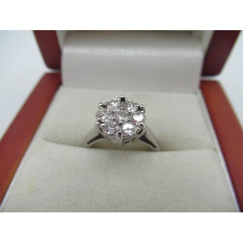 18ct white gold and diamond ring with seven diamonds in a cl...