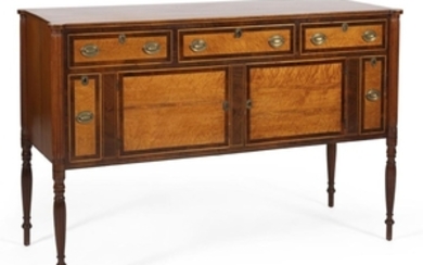 SHERATON SIDEBOARD ATTRIBUTED TO THE SEYMOUR FAMILY In mahogany with select mahogany and bird's-eye maple facings. Three side-by-sid..