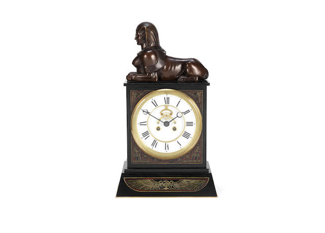 A late 19th Century French Egyptian revival patinated bronze and black Belgium marble mantle clock