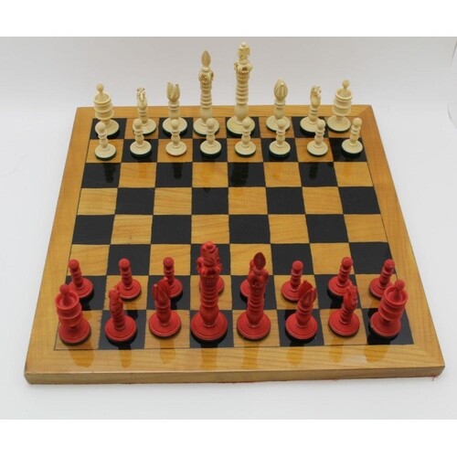 A 19TH CENTURY ANGLO-INDIAN CARVED & STAINED IVORY CHESS SET...