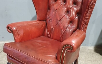 A CHESTERFIELD STYLE WINGBACK ARMCHAIR