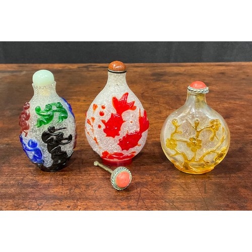 A Chinese Peking glass ovoid snuff bottle, decorated in red ...