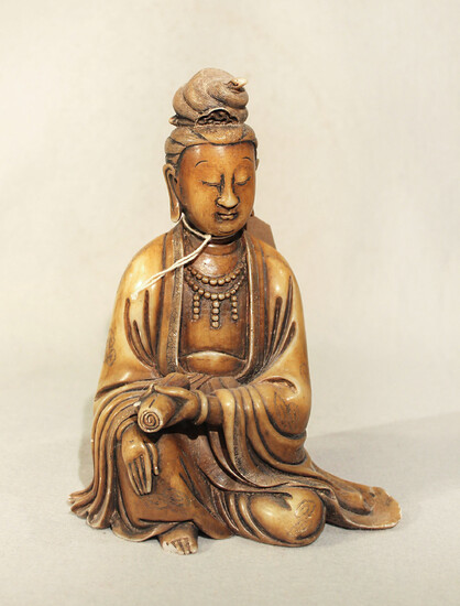 A Chinese carved soapstone figure of Guanyin, seated holding a scroll, Republic Period in Qing