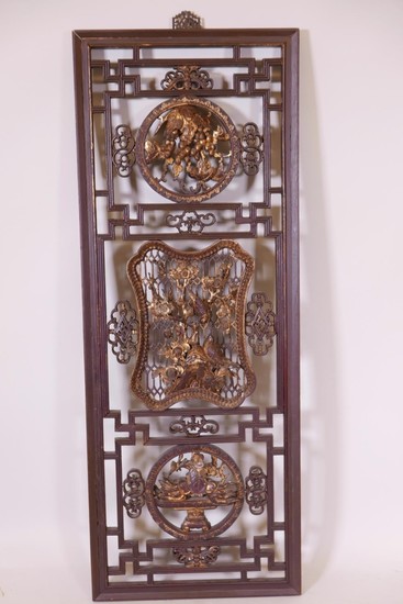 A Chinese lacquer panel, carved and pierced with parcel gilt...