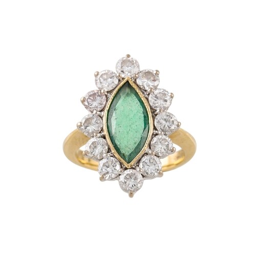 A DIAMOND AND EMERALD CLUSTER RING, the marquise cut diamond...