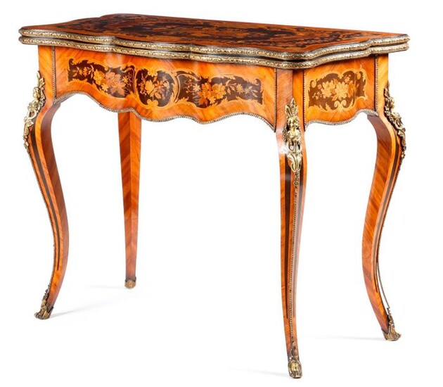 A FRENCH KINGWOOD AND MARQUETRY SERPENTINE CARD TABLE IN LOUIS XV STYLE LATE 19TH CENTURY with gilt bronze mounts and inlaid with panels of scrolls, leaves and flowers, the hinge and swivel top revealing a baize lined playing surface on cabriole legs...