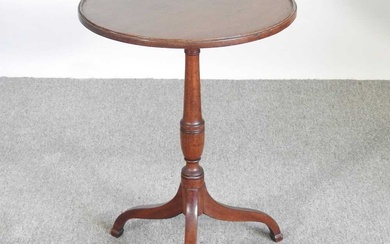 A George III mahogany wine table, on a reeded pedestal...