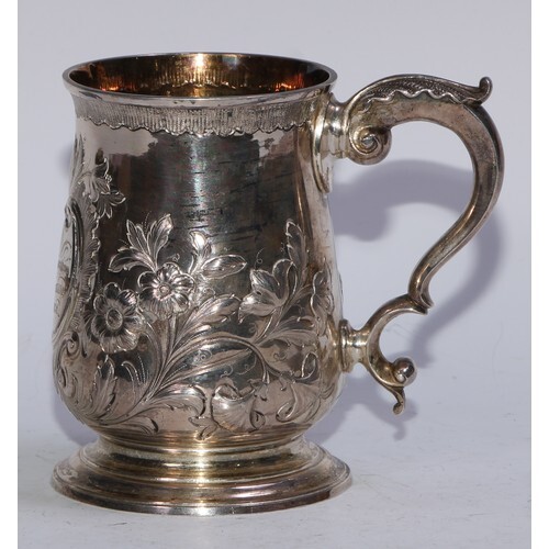 A George III silver baluster mug, repoussé chased with flowe...