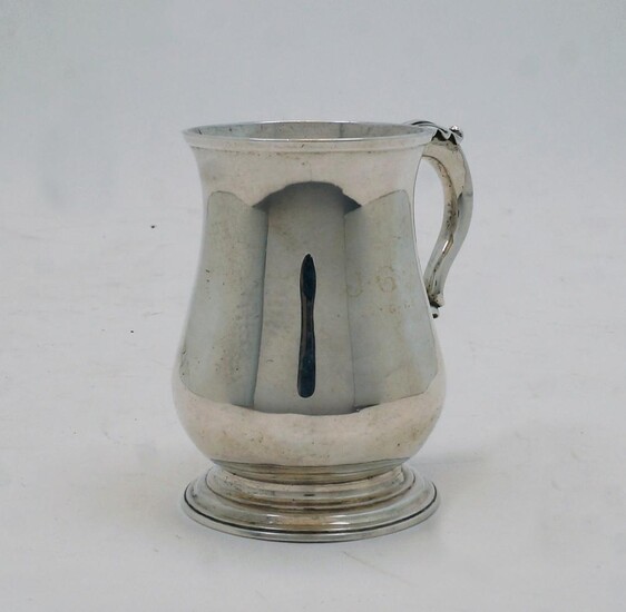 A George III silver mug, London, 1771, probably William Grundy, with acanthus leaf handle on stepped circular base, 10.2cm high, weight approx. 7.4oz
