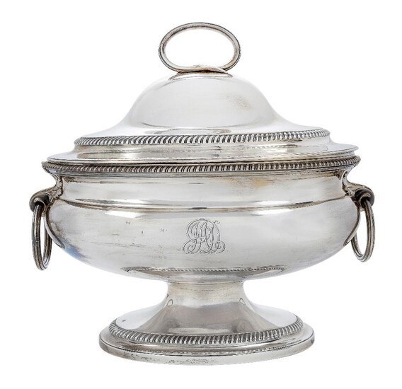 A George III silver soup tureen, London, 1788, Robert Sharp, the oval body flanked by foliate ring handles and raised on a gadrooned oval foot, with associated liner (London, 1792, possibly John Edwards III), the domed cover with stylised branch...