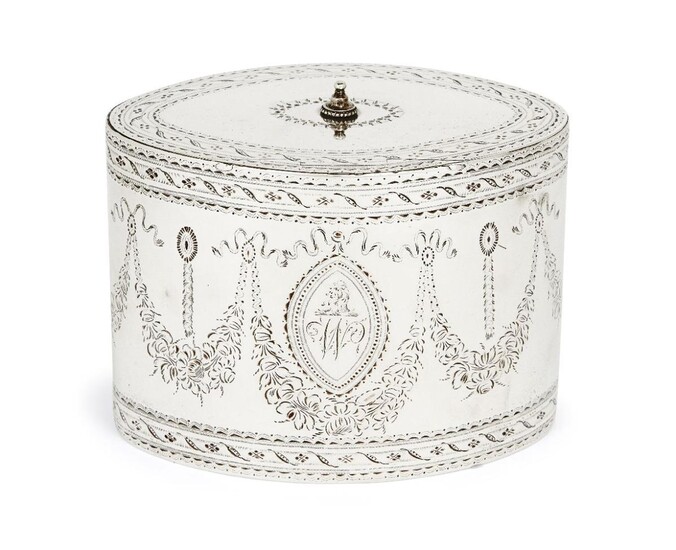 A George III silver tea caddy, London, 1786, Robert Hennell I, of oval form, the sides bright cut with floral garlands surrounding engraved cartouches, the hinged lid also decorated with bright cut patterns, 12.8cm wide, 9.2cm high, approx. weight...