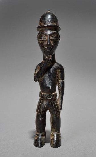 A Lobi colon standing figure Burkina Faso wearing...