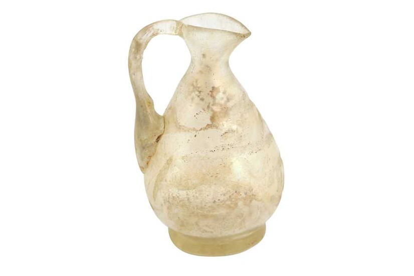 A MINIATURE MOULD-BLOWN WHEEL-CUT TRANSPARENT GLASS EWER Possibly Egypt, 10th century