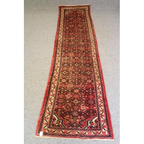 A PERSIAN TRIBAL WOOL RUNNER, 20th century, the red field wi...