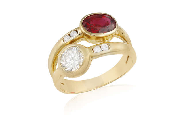 A RUBY AND DIAMOND RING Of crossover design,...
