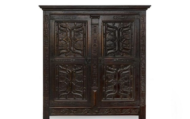 A Renaissance Revival Carved and Stained Oak Kas Height