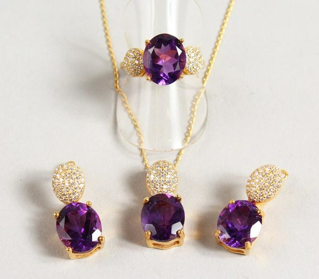 A SILVER AND GOLD PLATED THREE PIECE AMETHYST SET