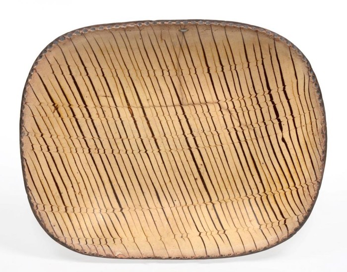 A Staffordshire Slipware Dish, 18th century, of rounded rectangular form...