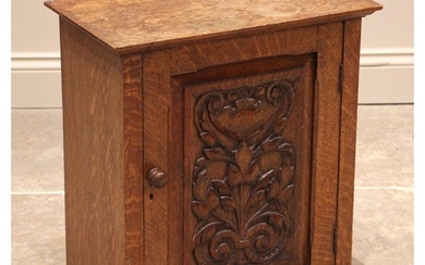 A Victorian carved oak wall cupboard, with an over-sailing t...