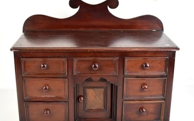 A Victorian miniature mahogany dresser base with shaped raised...