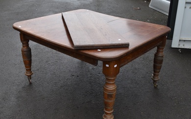 A Victorian oak wind out dining table, approx 138 x 122cm closed dimensions, with winder and