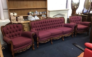 A Victorian style carved hardwood three-piece suite with scroll carved...