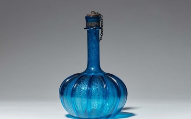 A blue glass bottle with ribbed decor
