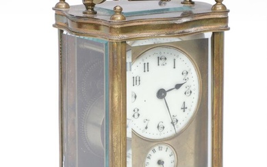 A carriage clock in brass case with sides of facet cut glass,...