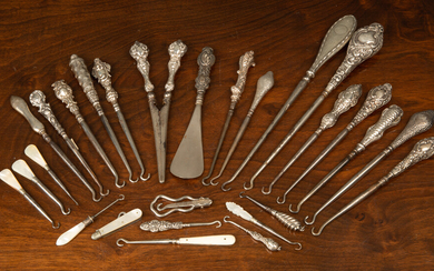 A collection of silver handled boot hooks and glove stretchers...