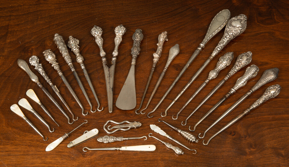 A collection of silver handled boot hooks and glove stretchers...