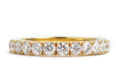 A diamond eternity ring set with numerous brilliant-cut diamonds weighing a total...