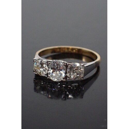 A diamond three stone ring set in 18ct gold & platinum, fing...