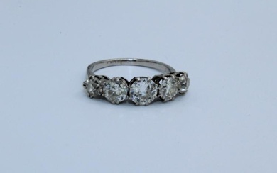 A five stone diamond ring in white metal, assessed as...