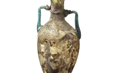 A folded Roman bottle with two handles made of glass, late 3rd - early 4th century