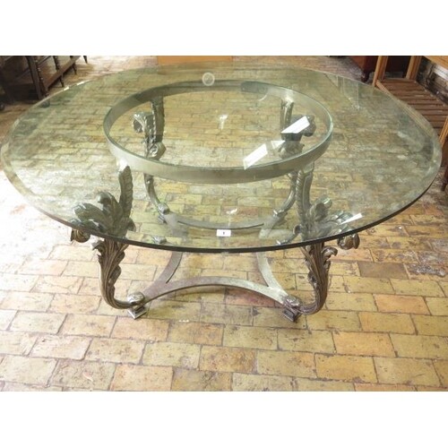 A good quality glass top table on a metal acanthus scroll ba...