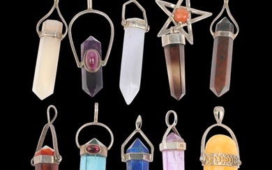 A group of silver-mounted gem set Chakra pendants, including...
