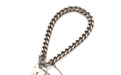 A heavy (22.5g) English hallmarked sterling silver curb link bracelet, W.J.Sutton, Birmingham 1977, fitted with a heart clasp and safety chain, L: 19cm x 6mm