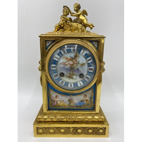 A late 19th century French gilt metal and porcelain mantle c...