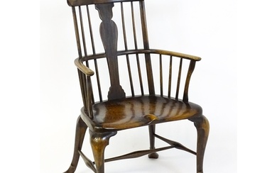 A late 19thC / early 20thC comb back Windsor chair with a va...
