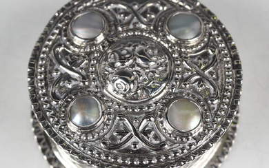 A late 19th/early 20th century German .800 silver circular box, the hinged lid inset with four mothe
