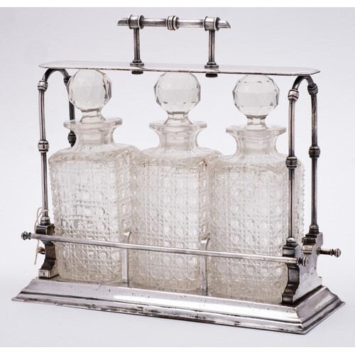 A late Victorian plated tantalus in Christopher Dresser styl...