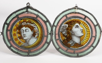 A pair of Aesthetic Movement stained glass Day and Night roundels, each painted with a portrait inside red and green glass borders, another stained glass panel with heraldic motif and an Aesthetic stained glass window decorated with a bird and tree...