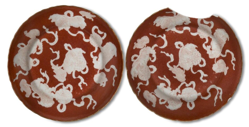 A pair of Chinese porcelain iron-red reverse-decorated 'shi' dishes, late Qing dynasty, each painted with five guardian lions with balls on coral-red ground, 13.5cm (2)